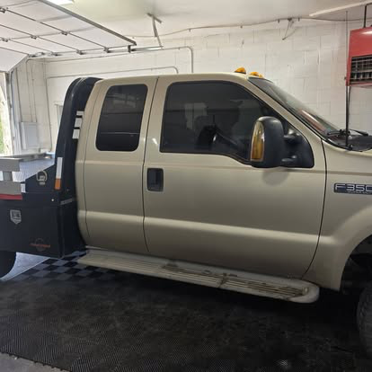 Ford F-350 flatbed in the shop bay after tint installation