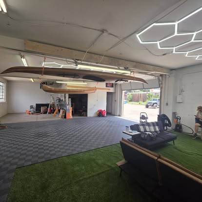 Inside the Cañon Auto Tinting Plus shop: checkered floor, hex lighting and the turf lounge area